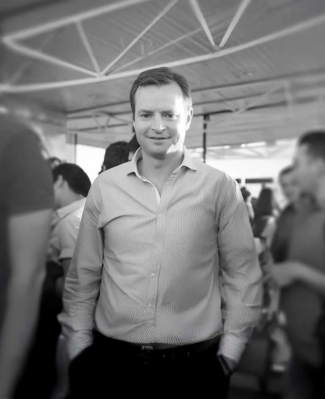 Michael Fichardt standing in growd with camera focused on him