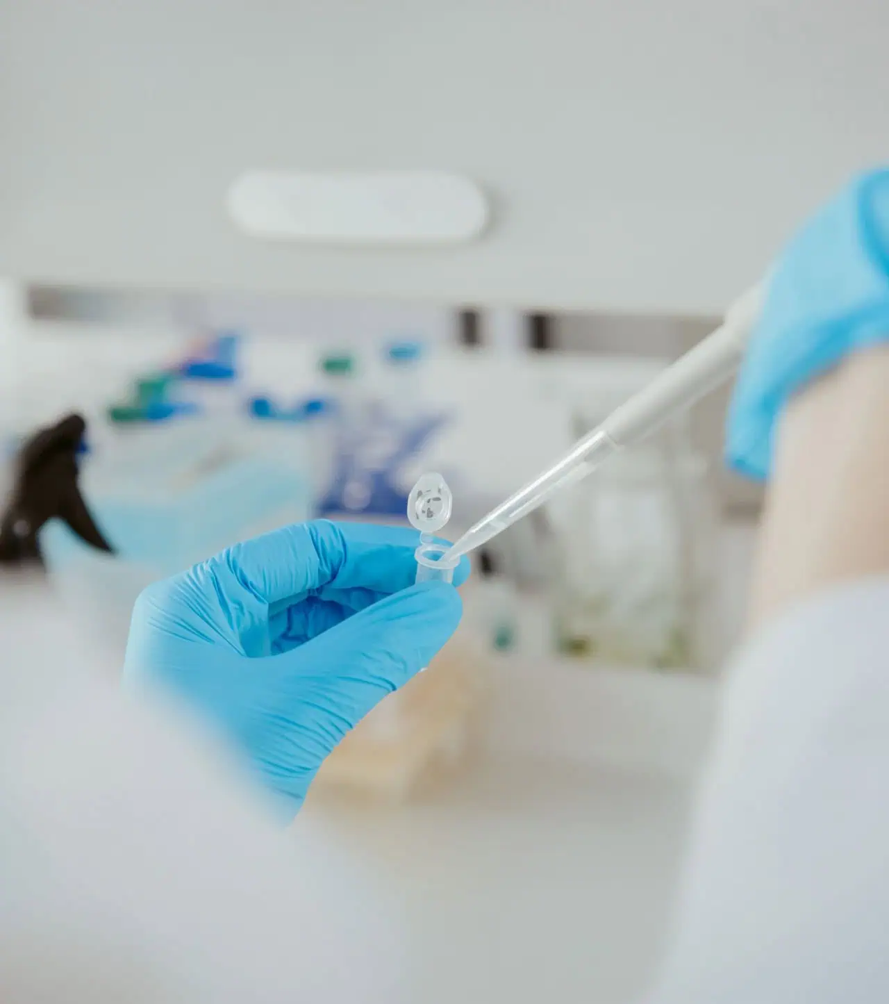Someone working with test tube in biotech lab Large